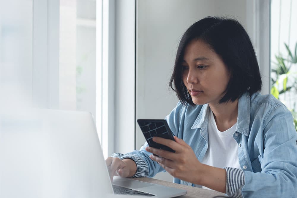 Female looking online to help find support for debt