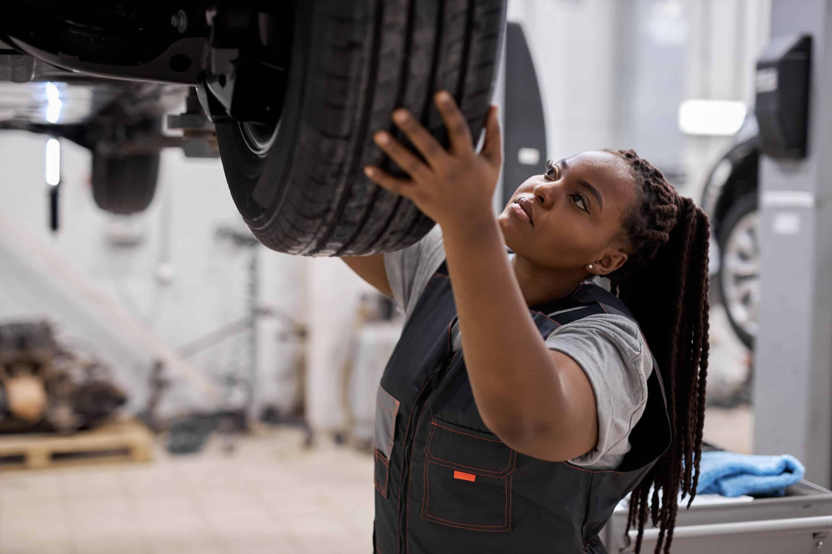 Mechanic adjusting the tire at repair garage